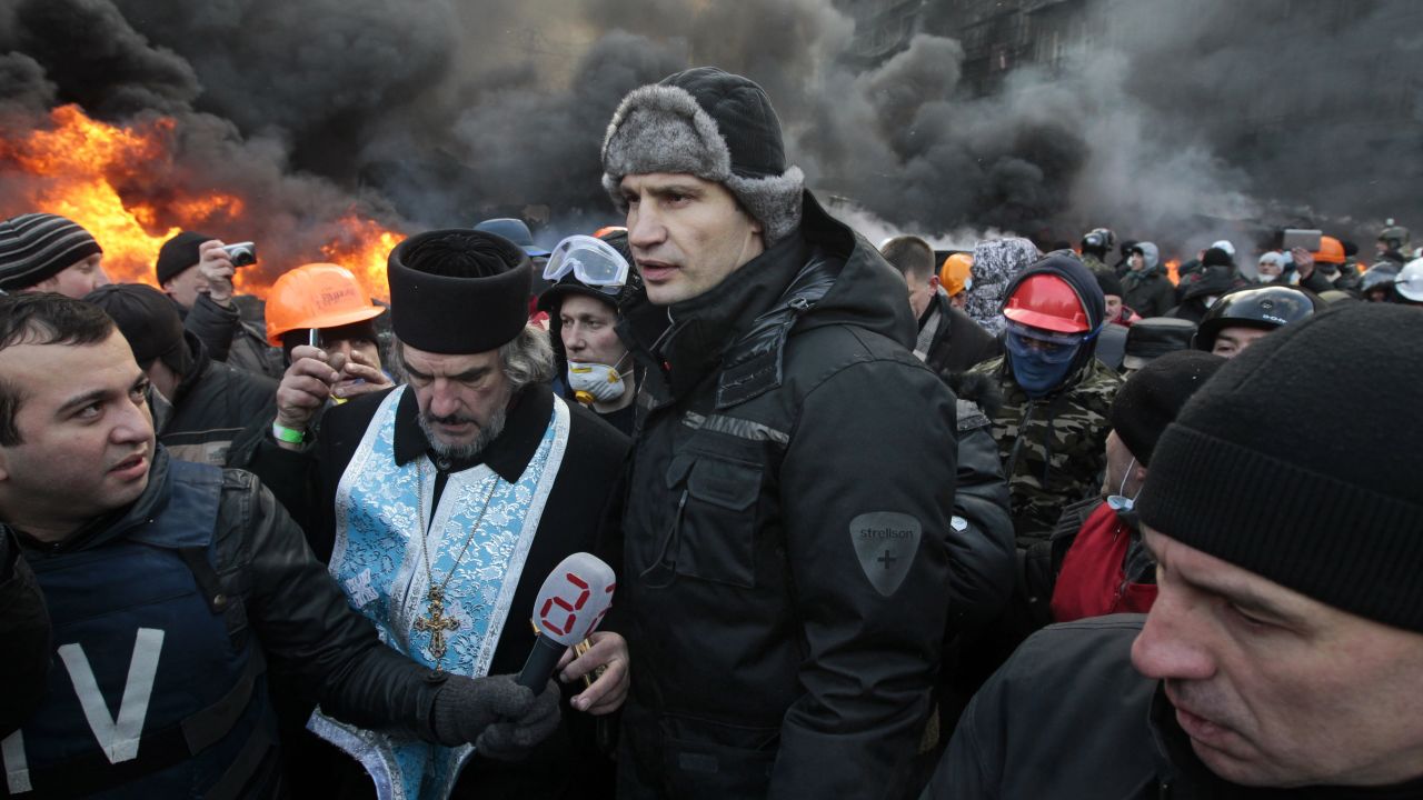 Opposition leader Vitali Klitschko, center, addresses protesters near the burning barricades between police and protesters in central Kiev on January 23.