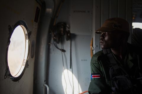 A Sudan People's Liberation Army soldier sits in a helicopter flying over Western Equatoria State on Tuesday, January 14.