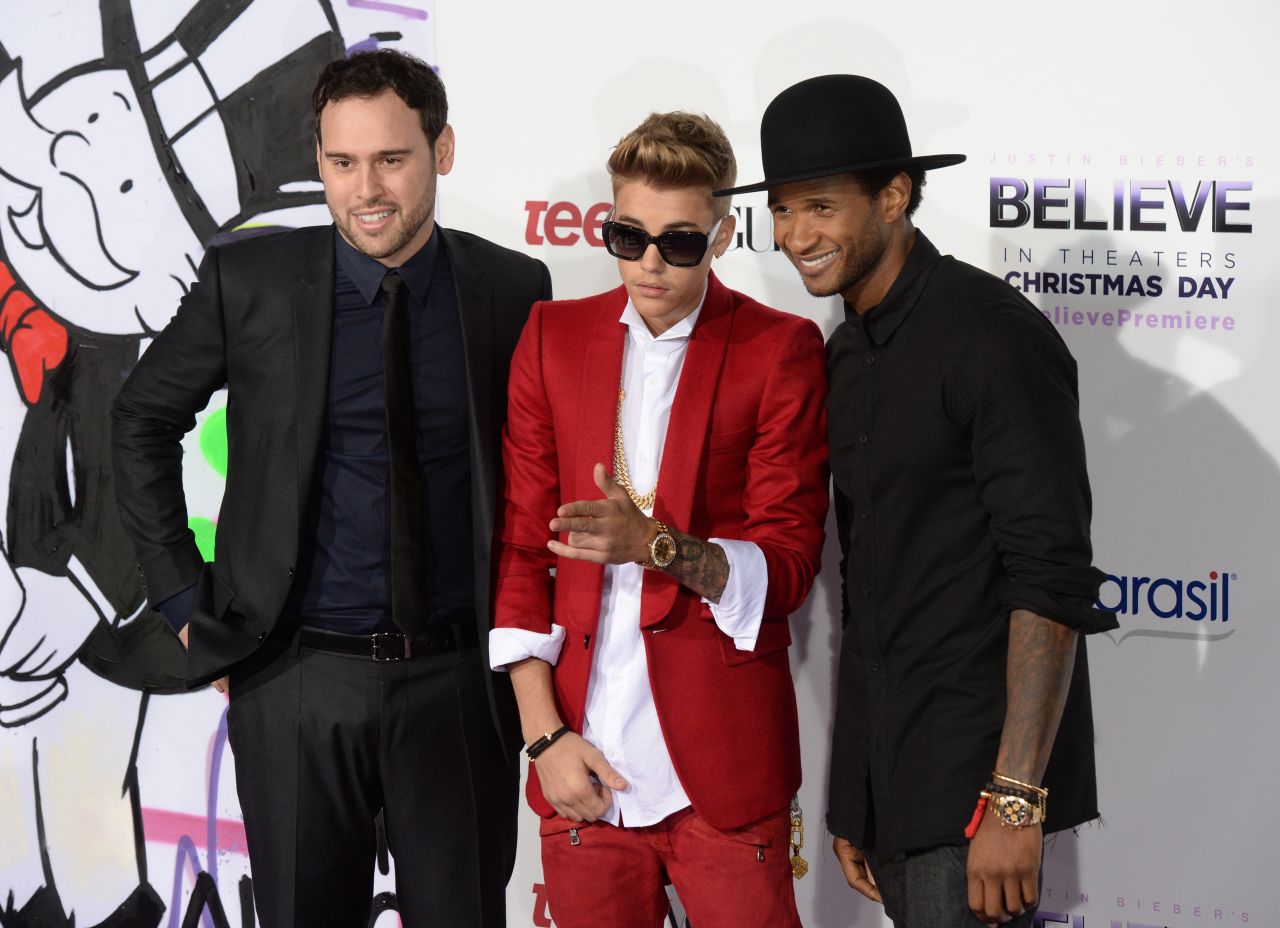 Justin Bieber is rarely spotted without a crew of a few friends, which sometimes also includes his longtime manager, Scooter Braun (pictured left). Along with R&B singer Usher, right, Braun has served as something of a mentor and guide to Bieber as he's grown up in the spotlight. 