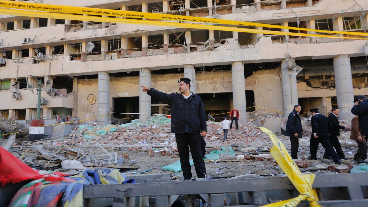 A police officer shouts at bystanders to keep away from the blast site.