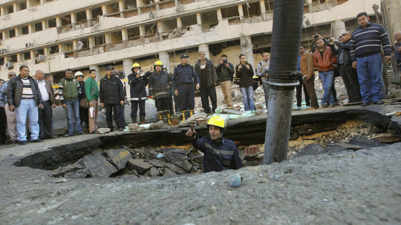 A firefighter checks a crater made by the blast.