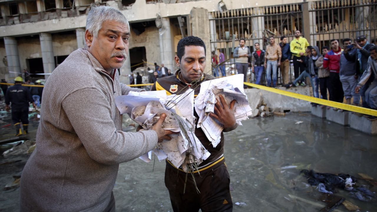 Men carry documents away from the site of the explosion.