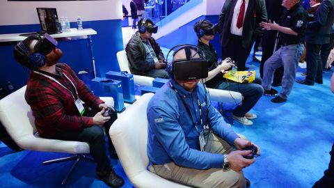 Attendees wear Oculus Rift HD virtual reality headsets as they play a multiplayer virtual reality dogfighting shooter game at CES in January. 