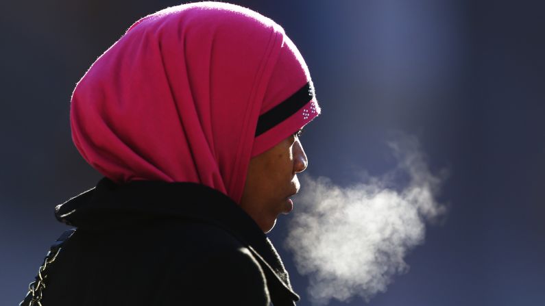 A woman exhales in the freezing temperatures of Philadelphia on Thursday, January 23. Driven by frigid arctic air, a powerful system is making a mess of things up and down the Eastern Seaboard, especially from Washington to Boston. More than a foot of snow has fallen in parts of the Northeast.