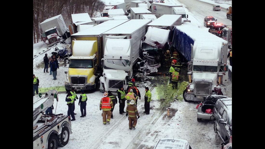 Emergency crews work at the scene of a massive pileup involving about 15 semitrailers and about 15 passenger vehicles and pickup trucks along Interstate-94 near Michigan City, Indiana, on January 23, in this photo provided by the Indiana State Police.