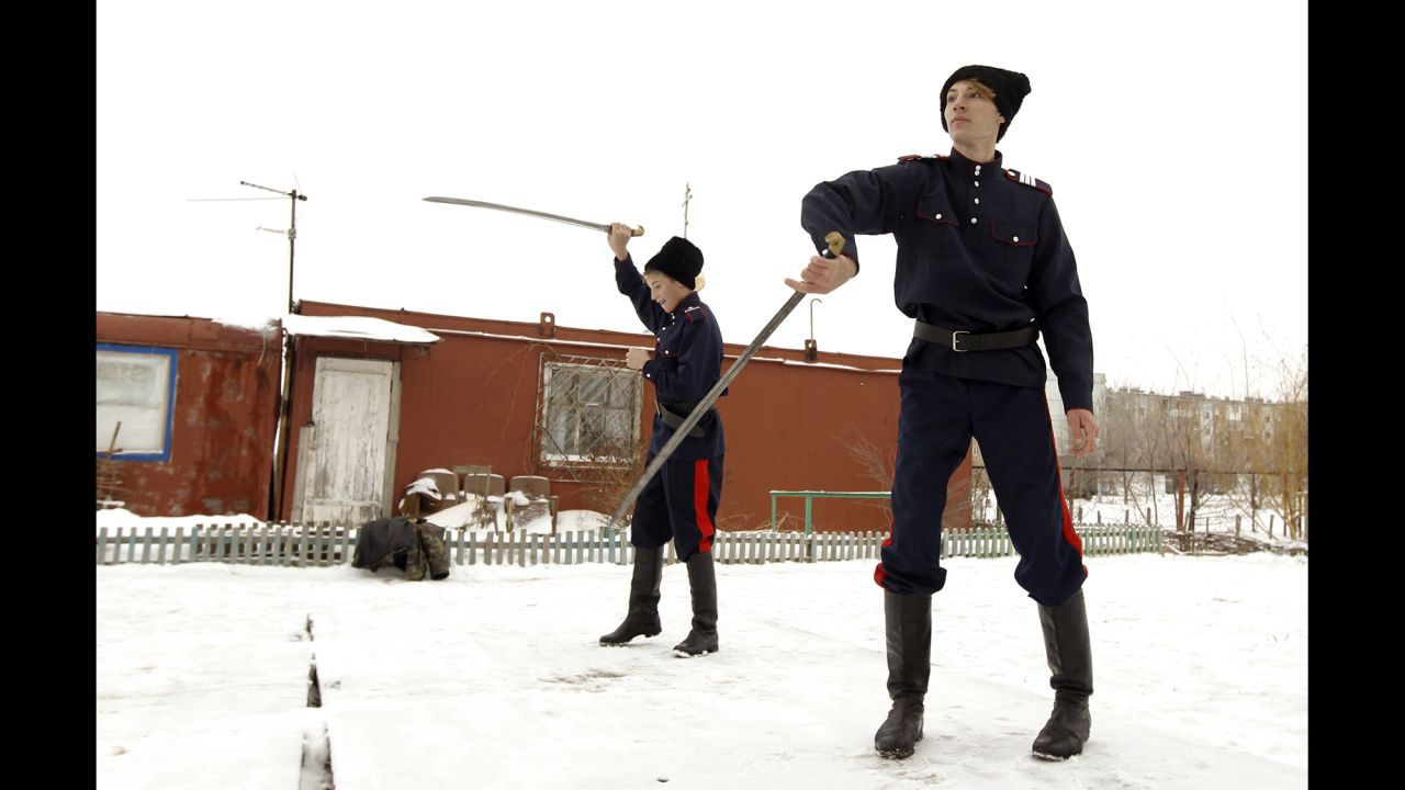 Young Russian Cossacks juggle swords in the town of Krasny Oktyabr, on the outskirts of the southern Russian city of Volgograd, in January 2014. Even before Russia was declared the host of the Winter Olympic Games, Cossacks were deployed to southern Russia to help maintain law.