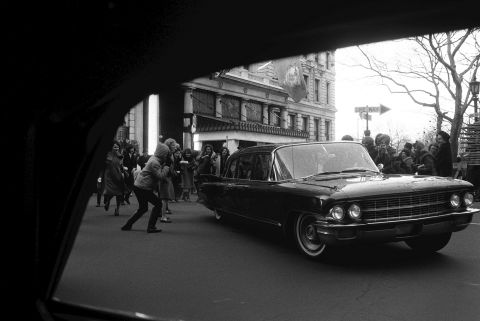 A car belonging to The Beatles is besieged by fans in New York on February 10, 1964.