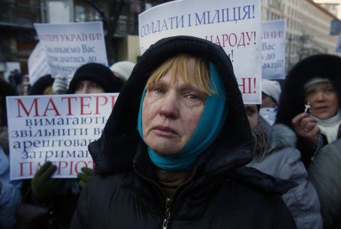 Ukrainian Oksana Tikhomirova cries as she urges riot police to stop the violence outside a government district in central Kiev on January 24.