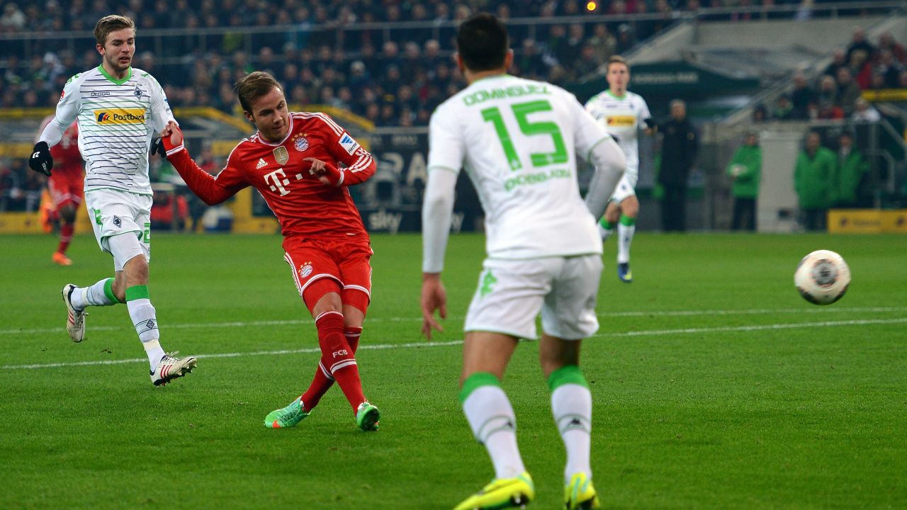 Mario Gotze sweeps home Bayern Munich's first goal against Monchengladbach as the Budesliga resumed on Friday night. 