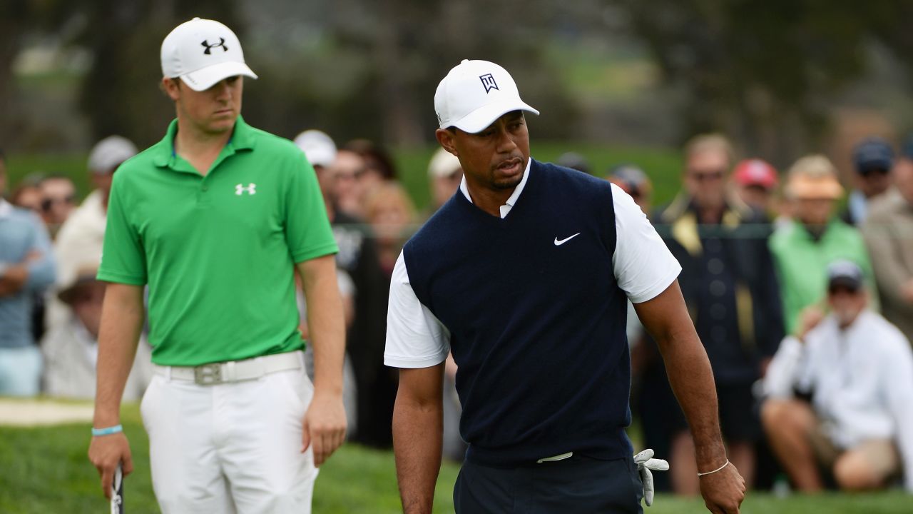 Look who's behind you! Halfway leader Jordan Spieth (left) watches on as Tiger Woods putts at Torrey Pines.