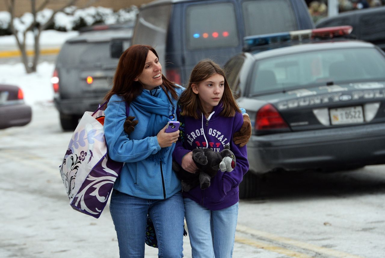 Two shoppers leave the mall after the shooting. 