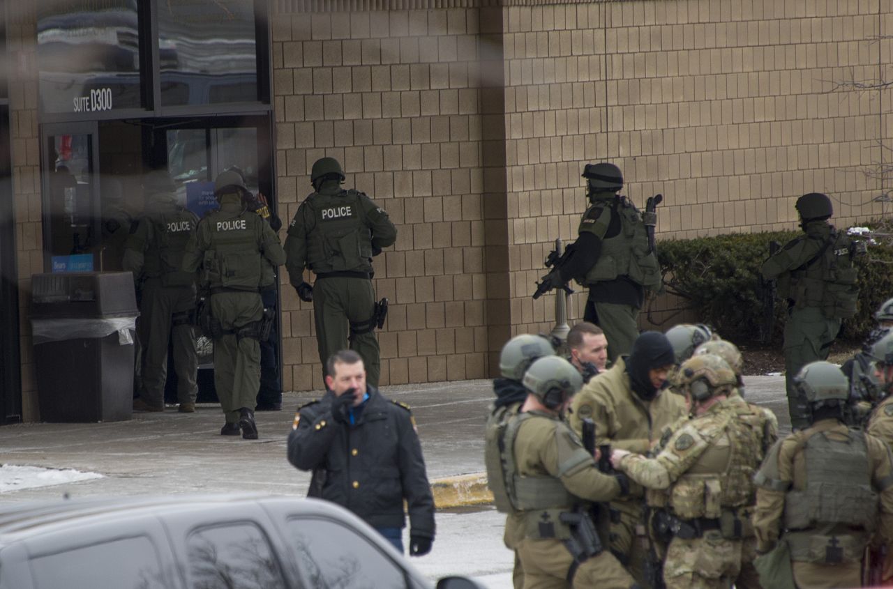 Police enter the Sears department store.