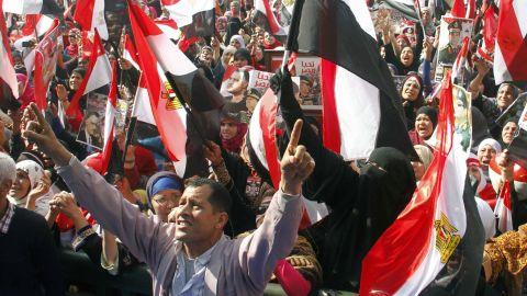Egyptians backing General Abdel Fattah al-Sisi wave national flags during a rally in Cairo's Tahrir Square on January 25, 2014. 