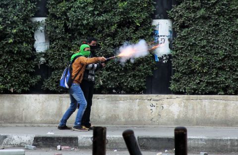 A Muslim Brotherhood supporter aims fireworks at pro-military demonstrators clashes in Cairo.