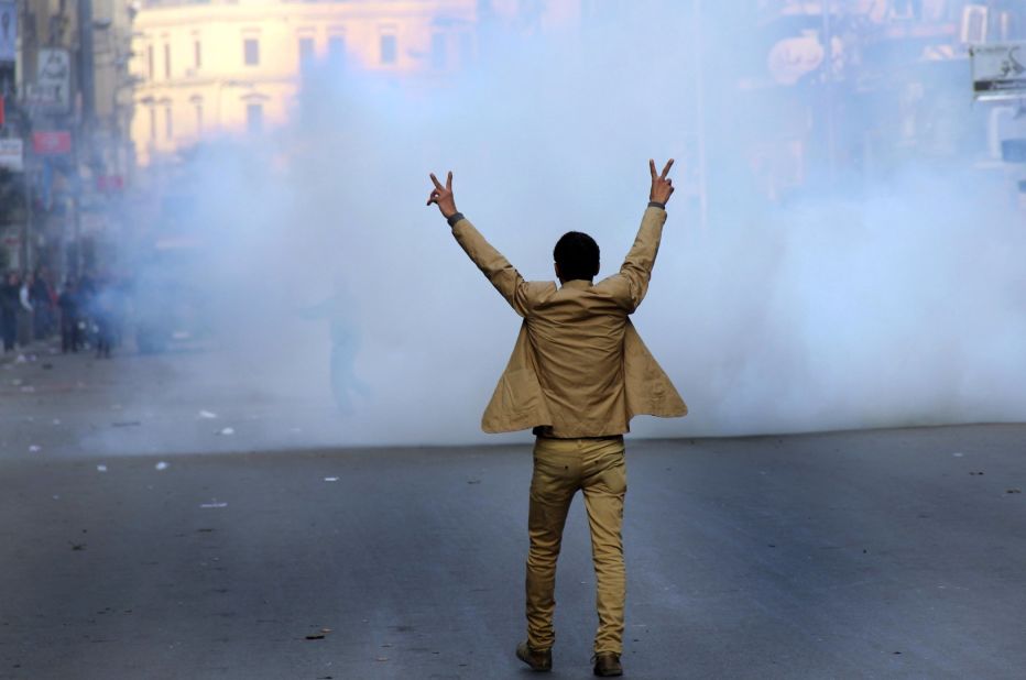 A supporter of the Egyptian military leadership flashes the victory sign during clashes with Muslim Brotherhood supporters.