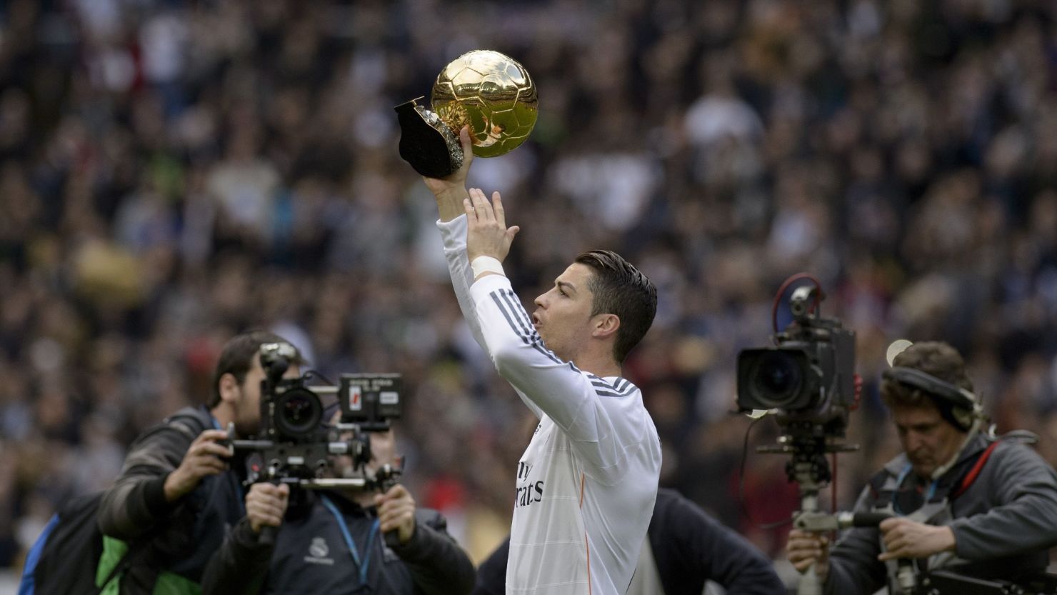 Cristiano Ronaldo shows the FIFA's Ballon d'Or to fans at the Bernabeu before the match against Granada on Saturday.