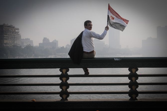 A man waves an Egyptian flag during a rally. 