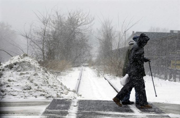 People walk in a snow squall January 25 in Trenton, New Jersey.
