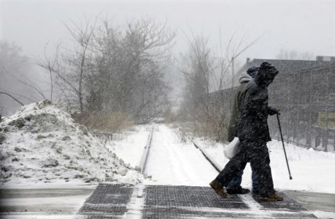 People walk in a snow squall January 25 in Trenton, New Jersey. 