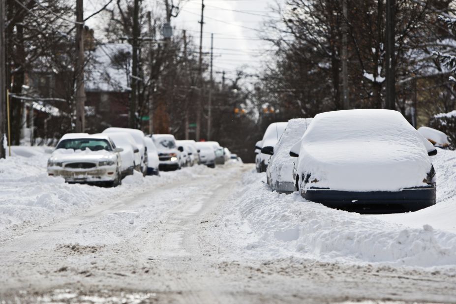 Cars sit in drifts and plowed snow on January 25 in Grand Rapids, Michigan.