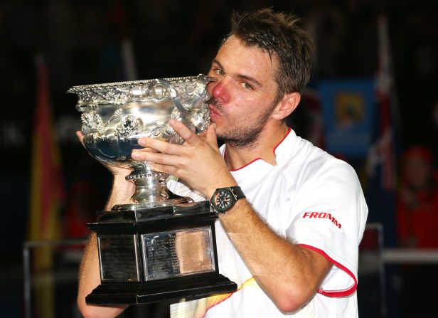 The 28-year-old Wawrinka kisses the Norman Brookes Challenge Cup as flashbulbs pop all around the Rod Laver Arena.
