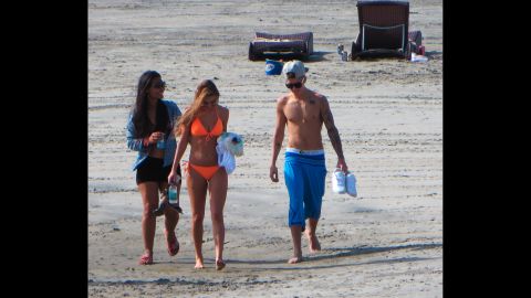 Justin Bieber walks on a beach in Panama on Saturday, January 25, two days after he was charged in Miami with drunken driving, resisting arrest and driving without a valid license. The pop star is accompanied by his new girlfriend, model Chantel Jeffries, who is wearing the orange bikini.