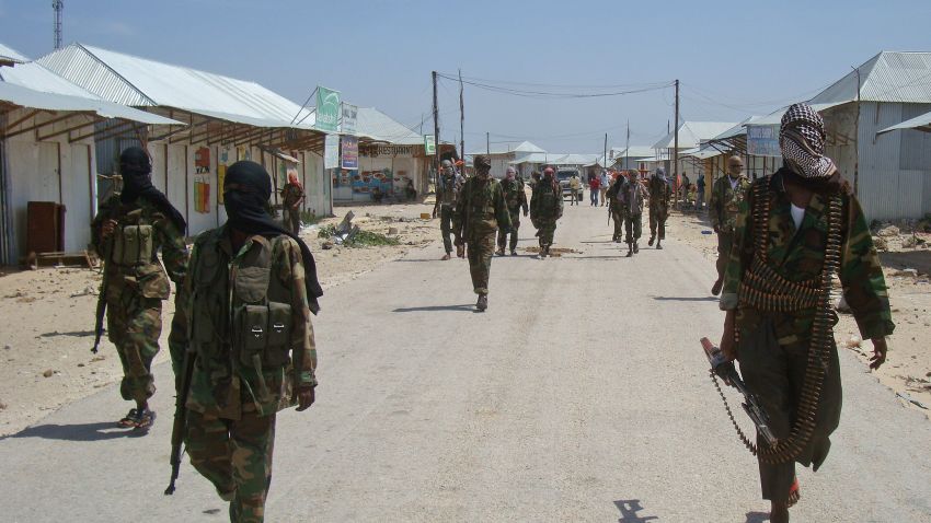 Al-Qaeda linked al-shabab recruits walk down a street on March 5, 2012 in the Deniile district of Somalian capital, Mogadishu, following their graduation. 