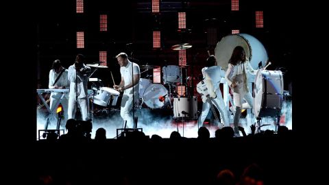 Part of the majesty of Kendrick Lamar's performance with Imagine Dragons during the 56th Grammys was the stark contrast of their all-white outfits against the set. Lamar and the band were ready and willing to stand out -- and they did.  