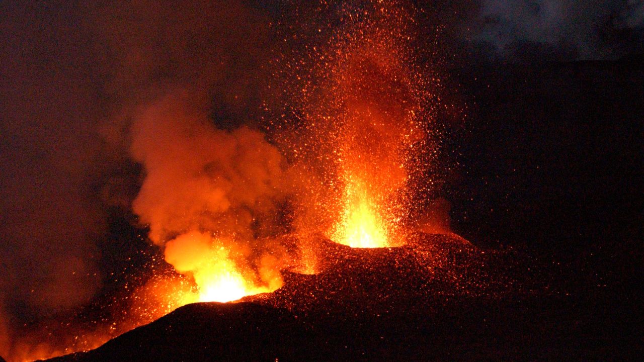 Mount Etna, Europe's most active volcano, explodes spilling lava down the mountain sides and shooting ash into the sky October 30, 2002 near the town of Nicolosi, near Catania, Italy. 