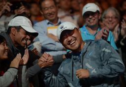 Jiang Shan (on the right) celebrates with Li Na's coach Carlos Rodriguez after she won the 2014 Australian Open