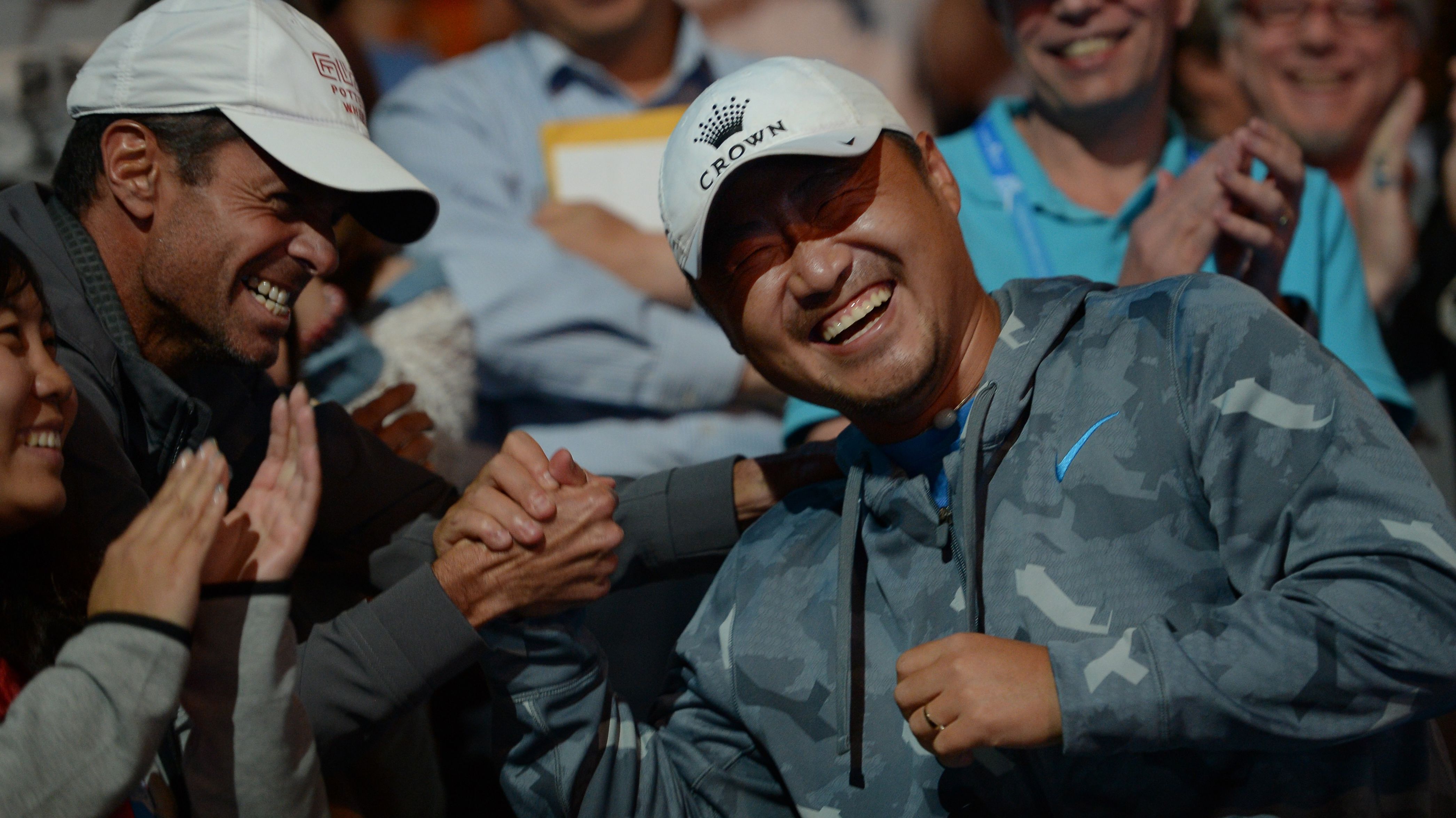 Jiang Shan (on the right) celebrates with Li Na's coach Carlos Rodriguez after she won the 2014 Australian Open