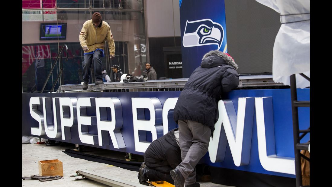 Workers put together a stage structure for Super Bowl activities in Times Square on Monday, January 27.