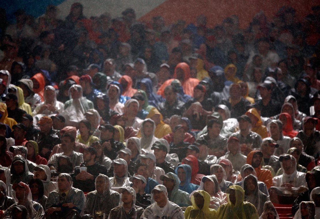 Fans sit in the rain as they watch Super Bowl XLI between the Chicago Bears and the Indianapolis Colts on February 4, 2007 at Dolphin Stadium in Miami Gardens, Florida. 