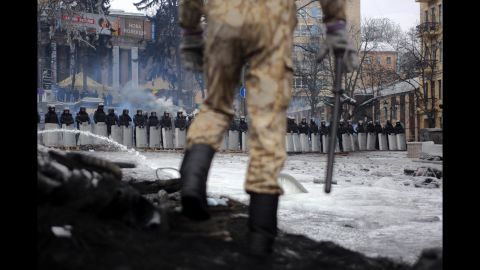 A protester stands on top of barricades in Kiev on Tuesday, January 28.
