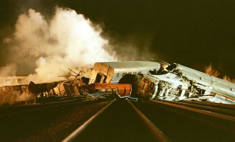 Rescue workers search the wreckage of a derailed Amtrak passenger train March 16, 1999, after it collided with a semi-trailer truck in Bourbonnais, Illinois, about 50 miles south of Chicago. Eleven people were reported dead and more than 100 were injured.