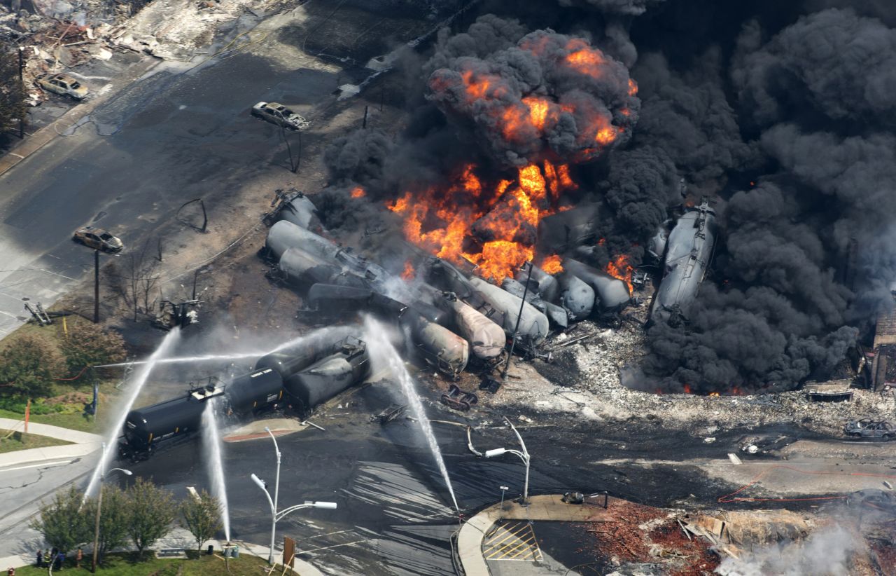 Smoke rises from railway cars after a train derailed in Lac-Megantic, Quebec, Canada, on July 6, 2013. A large swath of Lac-Megantic was destroyed after the derailment sparked several explosions. The train was carrying crude oil. At least 42 of the community's 6,000 residents died.