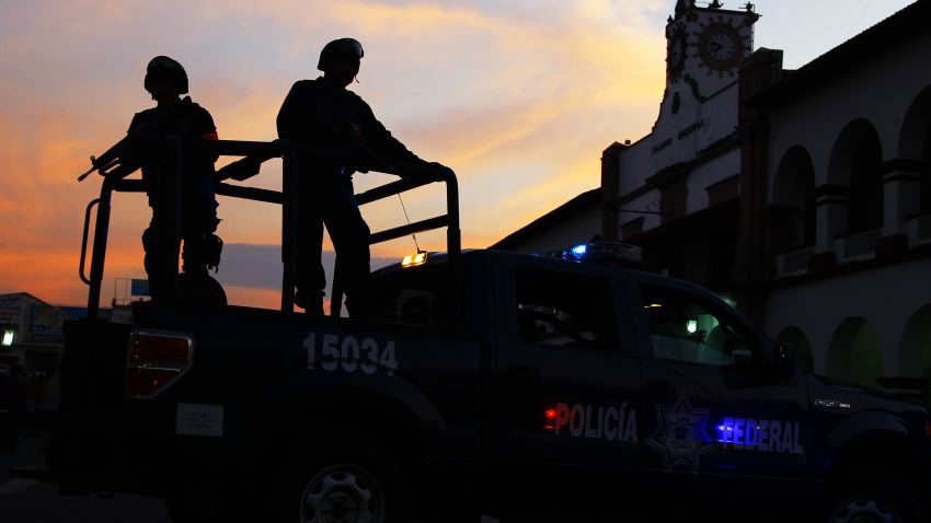Mexican federal police patrol during a march for peace in Apatzingan, Michoacan State, Mexico, on January 18, 2014.