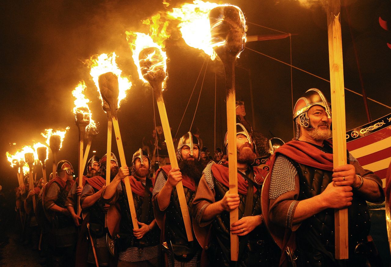 In Lerwick, a so-called "guiser squad" of bearded and armored gents (shown here in a previous Up Helly Aa) is led in a torchlit procession by the "jarl," their leader.