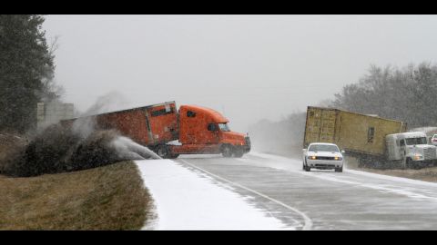 A semi slides off the road as the driver tries to avoid another wrecked truck as snow begins to accumulate on Interstate 65 in Clanton, Alabama, on January 28. Clanton lies between the capital, Montgomery, and the state's biggest city, Birmingham.