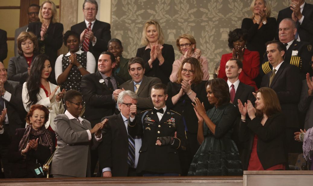 US Army Ranger Sgt. First Class Cory Remsburg, injured while serving in Afghanistan, acknowledges the crowd during a standing ovation for him as President Barack Obama delivers his State of the Union speech.