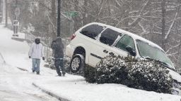 A vehicle ran off the road during a snow storm, Tuesday, Jan. 28, 2014 in Canton, Ga. A winter storm that would probably be no big deal in the North all but paralyzed the Deep South on Tuesday, bringing snow, ice and teeth-chattering cold, with temperatures in the teens in some places. (AP Photo/The Marietta Daily Journal, Kelly J. Huff/The Marietta Daily Journal/AP)  ATLANTA JOURNAL CONSTITUTION OUT; MAGS OUT; NO SALES