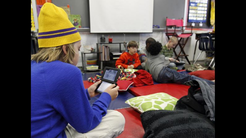 Gavin Chambers plays an electronic game January 29 at Oak Mountain Intermediate School in Indian Springs, Alabama. The <a href="index.php?page=&url=http%3A%2F%2Fwww.cnn.com%2F2014%2F01%2F28%2Fus%2Fwinter-weather%2Findex.html">severe weather forced thousands</a> of students to spend the night in various school buildings across the state.