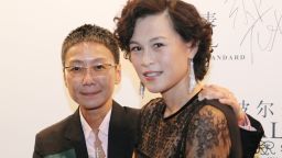 In this undated photo, Gigi Chao, right, daughter of the Hong Kong property tycoon Cecil Chao, poses with her partner Sean Eav at an event in Hong Kong. The daughter of the prominent Hong Kong tycoon who has offered $65 million to any man who can woo her away from her lesbian partner says she's not upset with her father. Gigi says she's on "very loving terms" with her father. He made world headlines this week when he offered the 500 million Hong Kong dollar marriage bounty after learning that his daughter had eloped with her partner to France. (AP Photo)