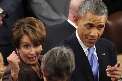 President Barack Obama, accompanied by House Minority Leader Nancy Pelosi of California, greets lawmakers and guests following his State of the Union address at the Capitol.