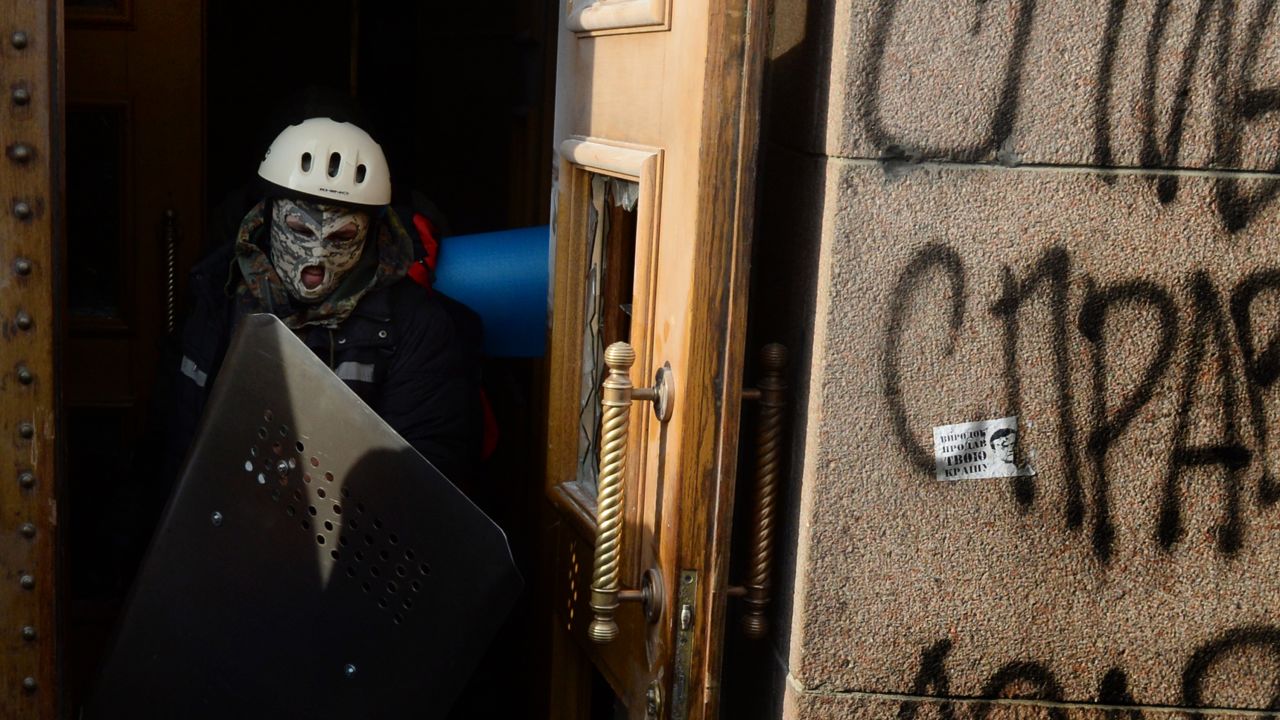 Activists from the radical Spilna Sprava (Common Cause) leave the agriculture ministry building they had occupied for several days, following clashes with representatives of right wing Ukraine opposition party Svoboda (Freedom) in Kiev, on January 29, 2014.