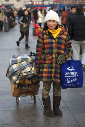 Xu Mei, a 43-year-old mother from Rizhao, Shandong province, is a part-time restaurant worker in Beijing.  She might not travel for New Year again next year, as her daughter is taking college entrance exams and they hope to spend more time together during that critical year. She bought a pink Hero pen and an English Text book as New Year gifts for her daughter and says Communication University of China is her daughter's dream school. Her standing-only ticket means she will spend the 12-hour journey home on her feet. 