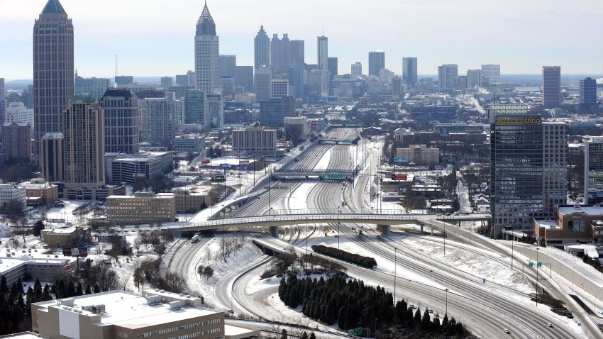 In this view looking south toward downtown Atlanta, the ice-covered interstate system is empty after a winter snow storm   slammed the city with over 2 inches of snow that turned highways into parking lots when motorists abandoned their vehicles creating massive traffic jams lasting through Wednesday, Jan. 29, 2014, in Atlanta. While such amounts of accumulation barely quality as a storm in the north, it was enough to paralyze the Deep South. (AP Photo/David Tulis)