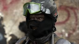 A masked Ukrainian anti-government protester stands at a roadblock in Kiev on January 29, 2014.
