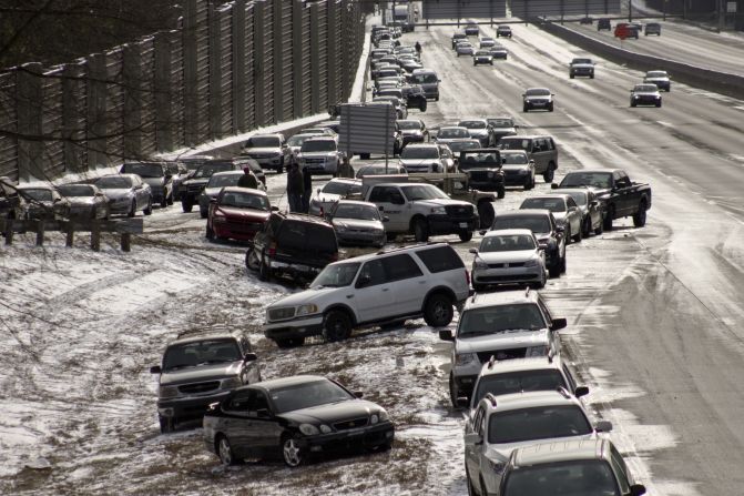 As of Wednesday afternoon, hundreds of cars were still stranded on Atlanta's interstates, as seen in this photo taken on a GA 400 exit by iReporter <a href="index.php?page=&url=http%3A%2F%2Fireport.cnn.com%2Fdocs%2FDOC-1079567">Dylan Wintersteen</a>. "It's bizarre to see all the cars people abandoned and just left last night," he said.