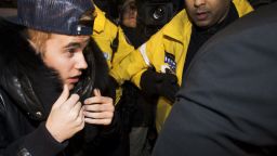 Justin Bieber is swarmed by media, fans and police officers as he turns himself in for an alleged assault charge on Wednesday, January 29.